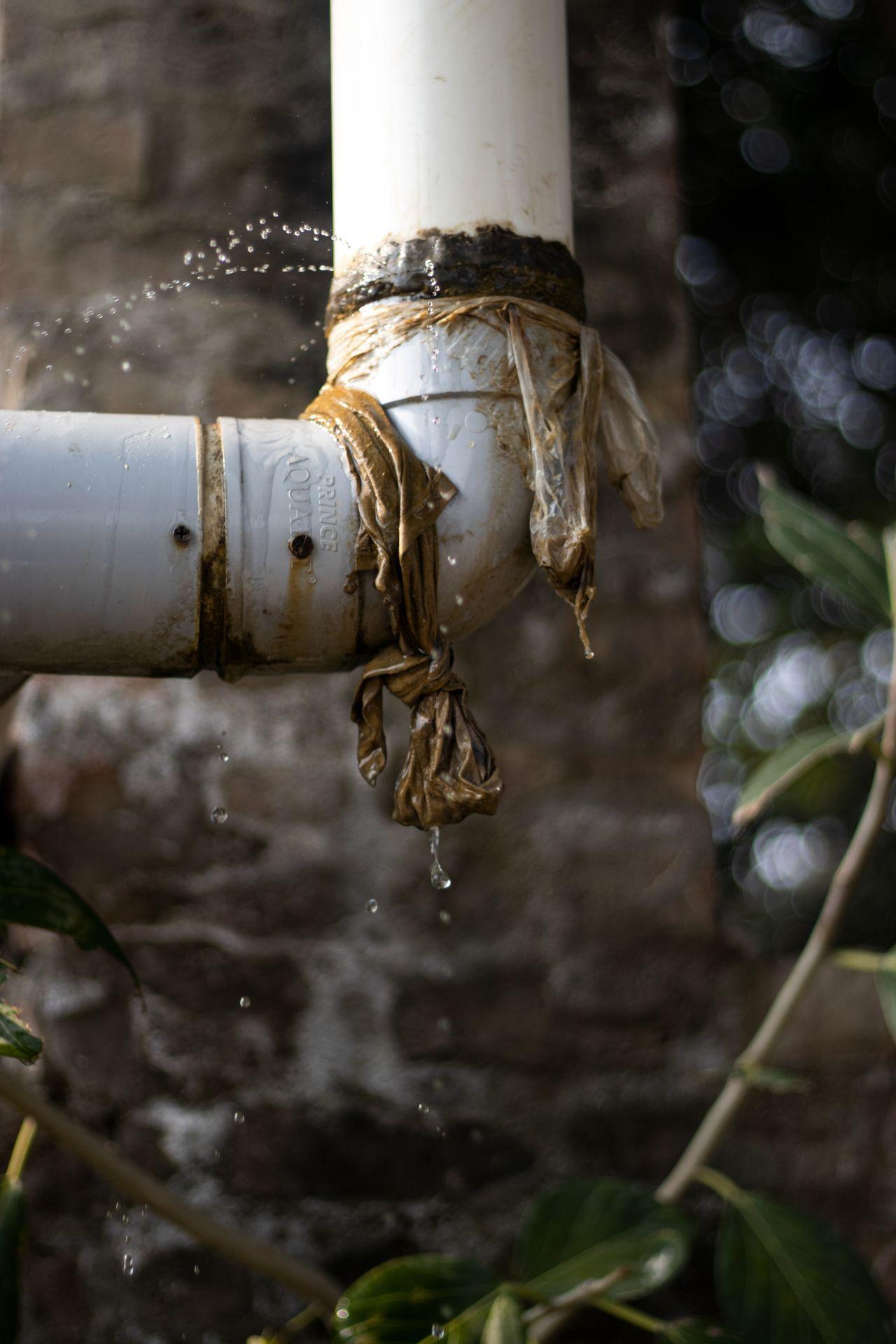 Burst water pipe leaking and spraying water before repair