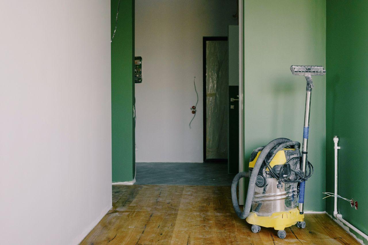Truck-mount style extractor removing water from a flooded room